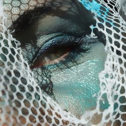 Close-up portrait of woman eye with spooky make-up