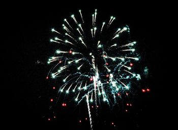 Low angle view of firework display in sky at night