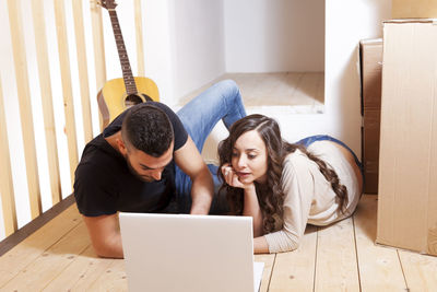 Young woman using laptop at home