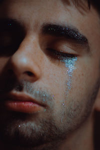 Close-up of man with glitter on face