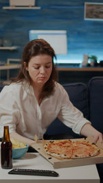 Young woman sitting at table