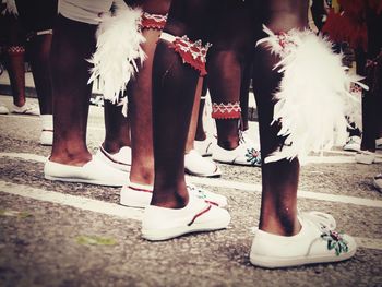 Low section of woman standing on tiled floor
