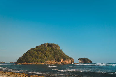 Scenic view of sea against clear blue sky