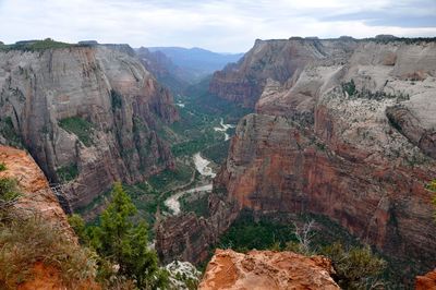 Scenic view of river and rocky mountains