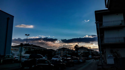 Buildings against cloudy sky