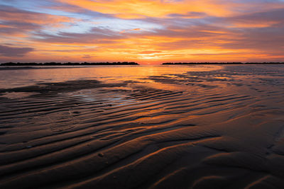 Scenic view of beach against sky during sunset