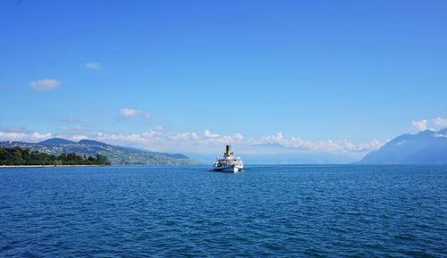 Crise ship  by sea against blue sky