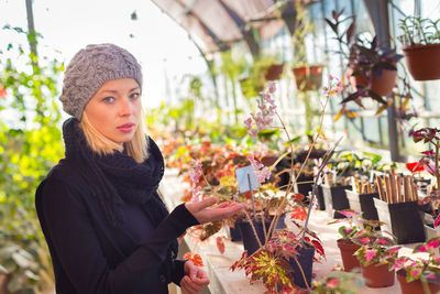 Portrait of woman standing at market stall