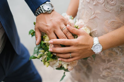 Wedding bouquet in the hands of the bride and groom