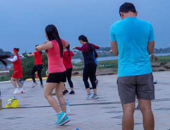 Rear view of people walking outdoors