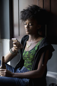 Young woman looking at her cell phone