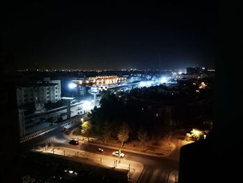 High angle view of illuminated cityscape against sky at night