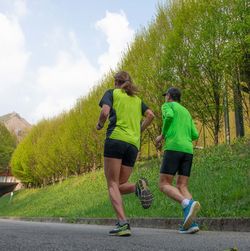 Rear view of couple walking on road