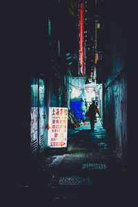 Rear view of people walking on street in city