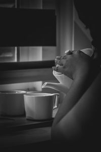 Side view of woman holding coffee cup