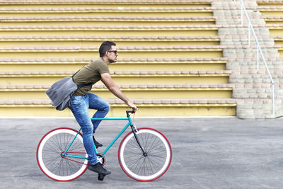 Low section of man riding bicycle