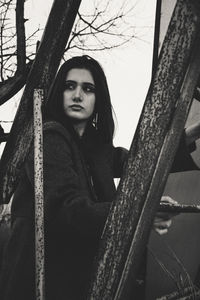 Portrait of a young woman sitting outdoors