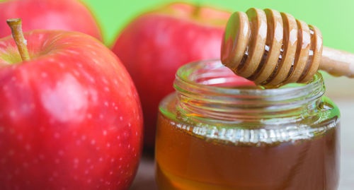 Close-up of apples in glass jar on table