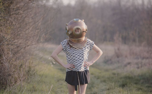 Woman wearing mask while standing on land