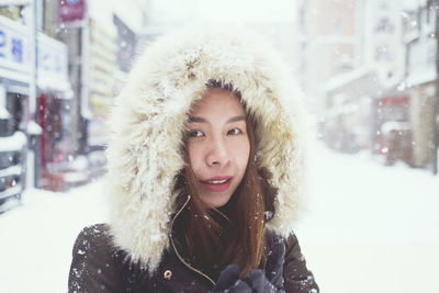 Portrait of young woman in snow