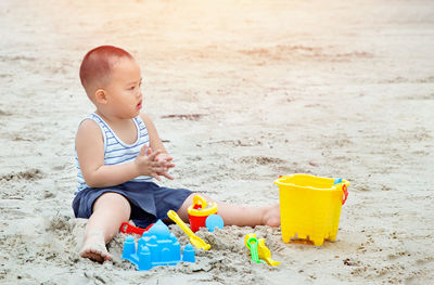 Boy playing with toy on beach