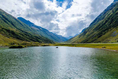 Scenic view of lake and mountains against sky