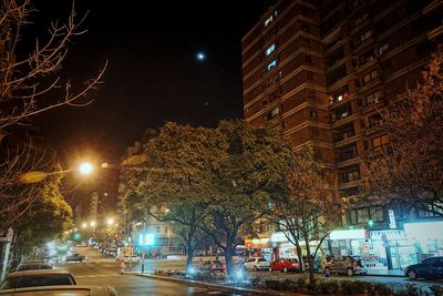 Illuminated buildings against sky at night