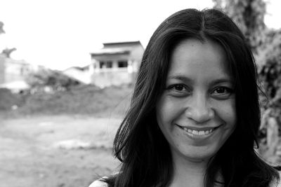 Close-up portrait of smiling young woman