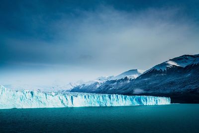 Scenic view of lake against sky during winter