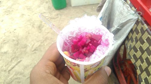 Cropped hand holding ice cream