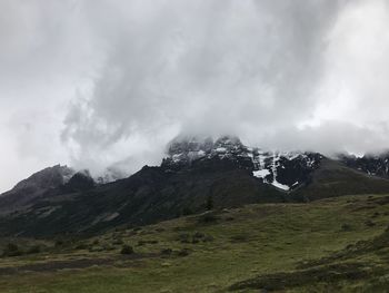 Scenic view of mountains against cloudy sky