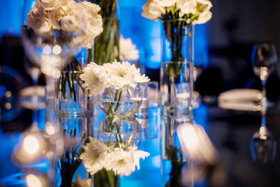 Close-up of white flowers on glass table
