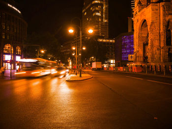 Illuminated city street and buildings at night