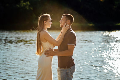 Declarations of love, candid couple in love holding hands on nature background.