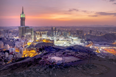 High angle view of illuminated buildings against sky during sunset