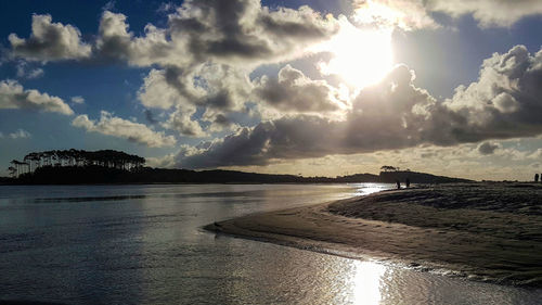 View of beach against cloudy sky