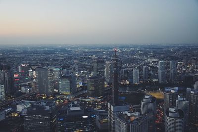 High angle view of illuminated buildings against sky in city