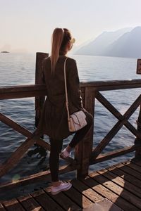 Rear view of woman looking at sea against sky