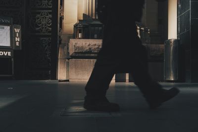 Silhouette woman walking in building