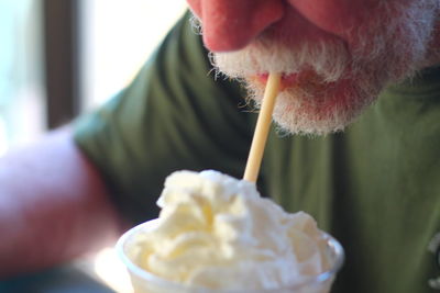 Close-up of hand holding ice cream