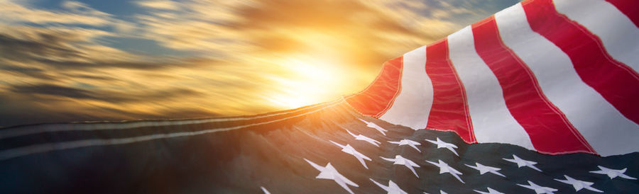 Close-up of flag against sky during sunset