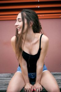Beautiful young woman sitting outdoors