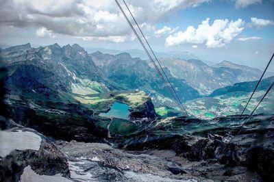 Scenic view of mountains against cloudy sky