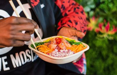 Midsection of man holding food