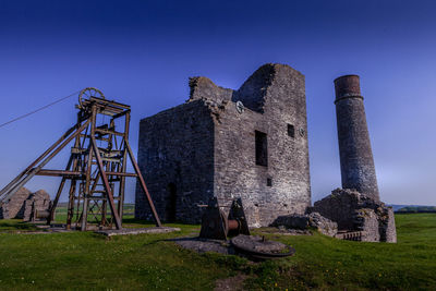 Old ruin building against blue sky