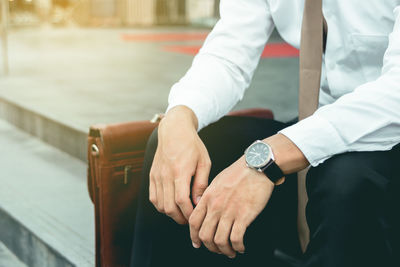 Midsection of businessman sitting on steps