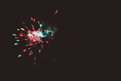 Low angle view of firework display at night