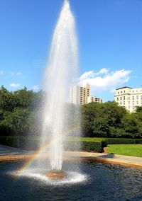 Water splashing in fountain against sky in city