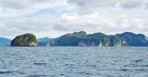 Panoramic view of sea and mountains against sky