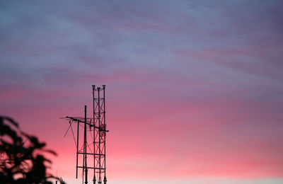 Selective focus at digital tv transmission tower on the roof with twilight background